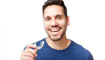 Man holding clear aligner