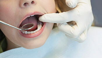 Dentist examining a child's teeth