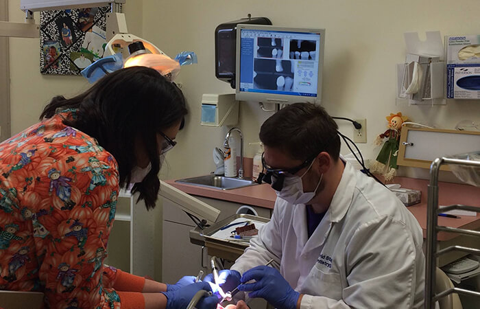 Dental volunteers working on a patient's teeth