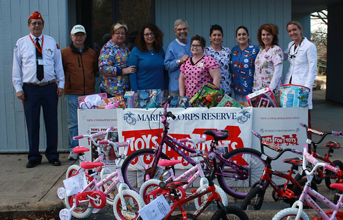 Dr. Albert Payne and his Toys for Tots team posing with their toys