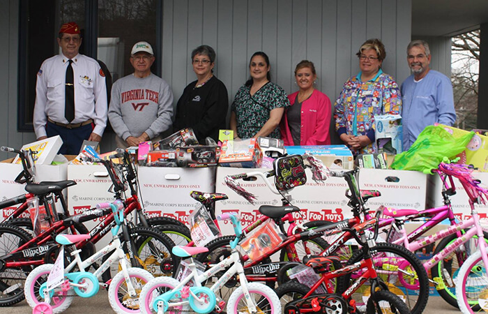 Dr. Albert Payne and his Toys for Tots volunteers grouping around their bikes