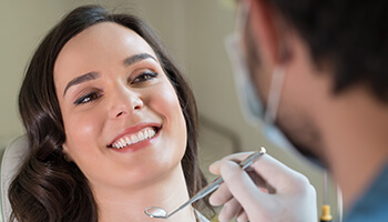 Chatham cosmetic dentist conversing with female patient