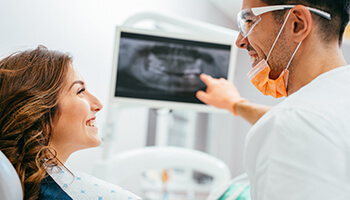 Dentist examining digital x-ray