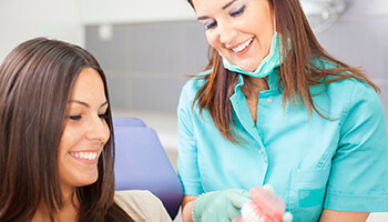 Danville dentist showing patient a model of the teeth