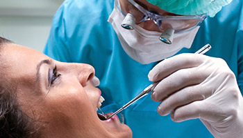 Danville Dental Services Dentist closely examining patient