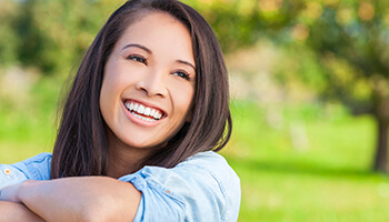 Young woman smiling outdoors