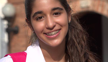 Teenage girl with braces smiling outdoors