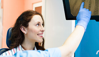 Female dental patient viewing a computer screen before root canal therapy in Danville