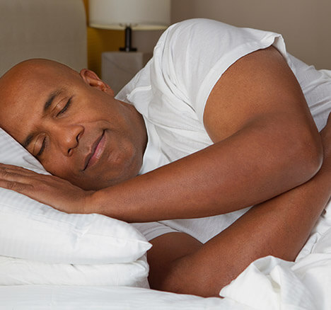 Man soundly asleep in bed