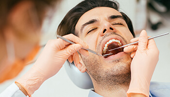 Dentist working on male patient