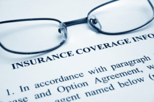 dental insurance documents and glasses