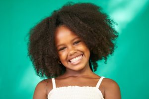 little girl smiling with perfect teeth