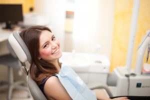 A woman smiling in the dental chair.
