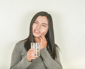 Woman holding teeth in pain