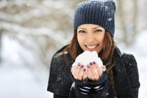 Woman smiling with snow