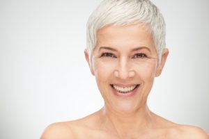 older woman smiling with silver hair