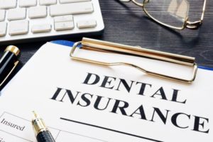 Closeup of dental insurance paperwork on clipboard