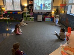 children watching a video about oral health care