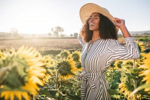 smiling woman flowers sun