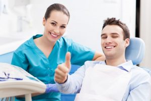 man giving thumbs-up during dental checkup in Danville