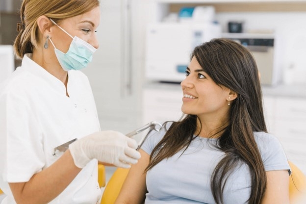 patient smiling while talking to dentist  