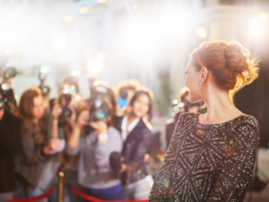 a celebrity with dental implants posing for cameras