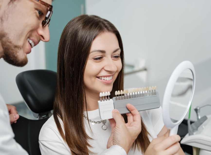 Dentist showing patient veneers