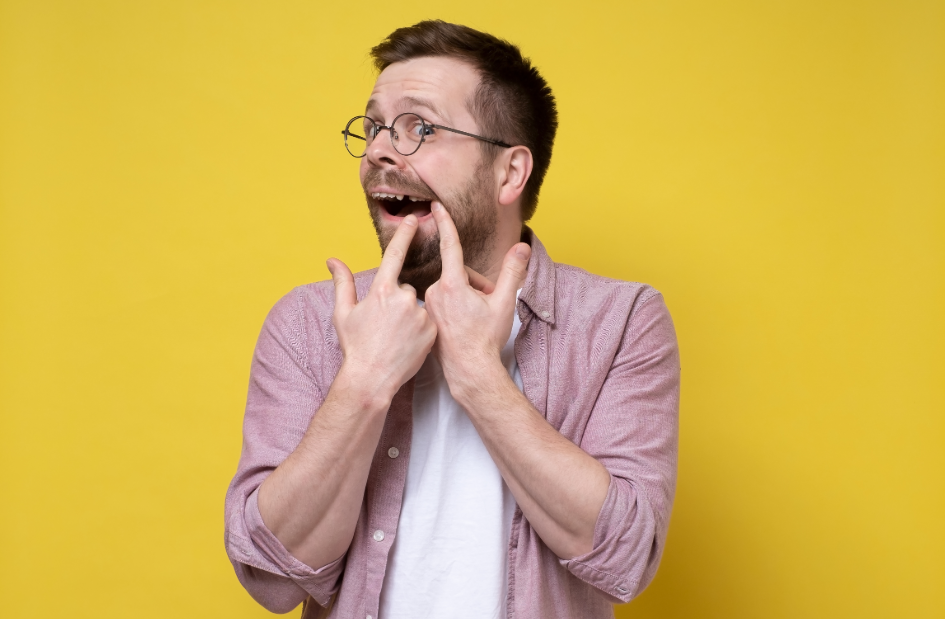 Man pointing at missing tooth